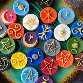 Colorful tealight candles with Pagan symbols ~ triple moon, star and moon, pentagram, runestave, Celtic knot, triskele