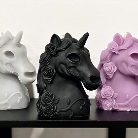 unicorn skull candles with flowers in their mane